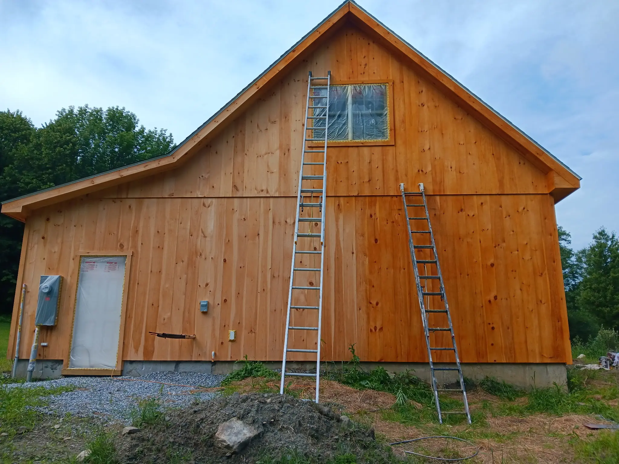 Barn garage being stained in a natural color