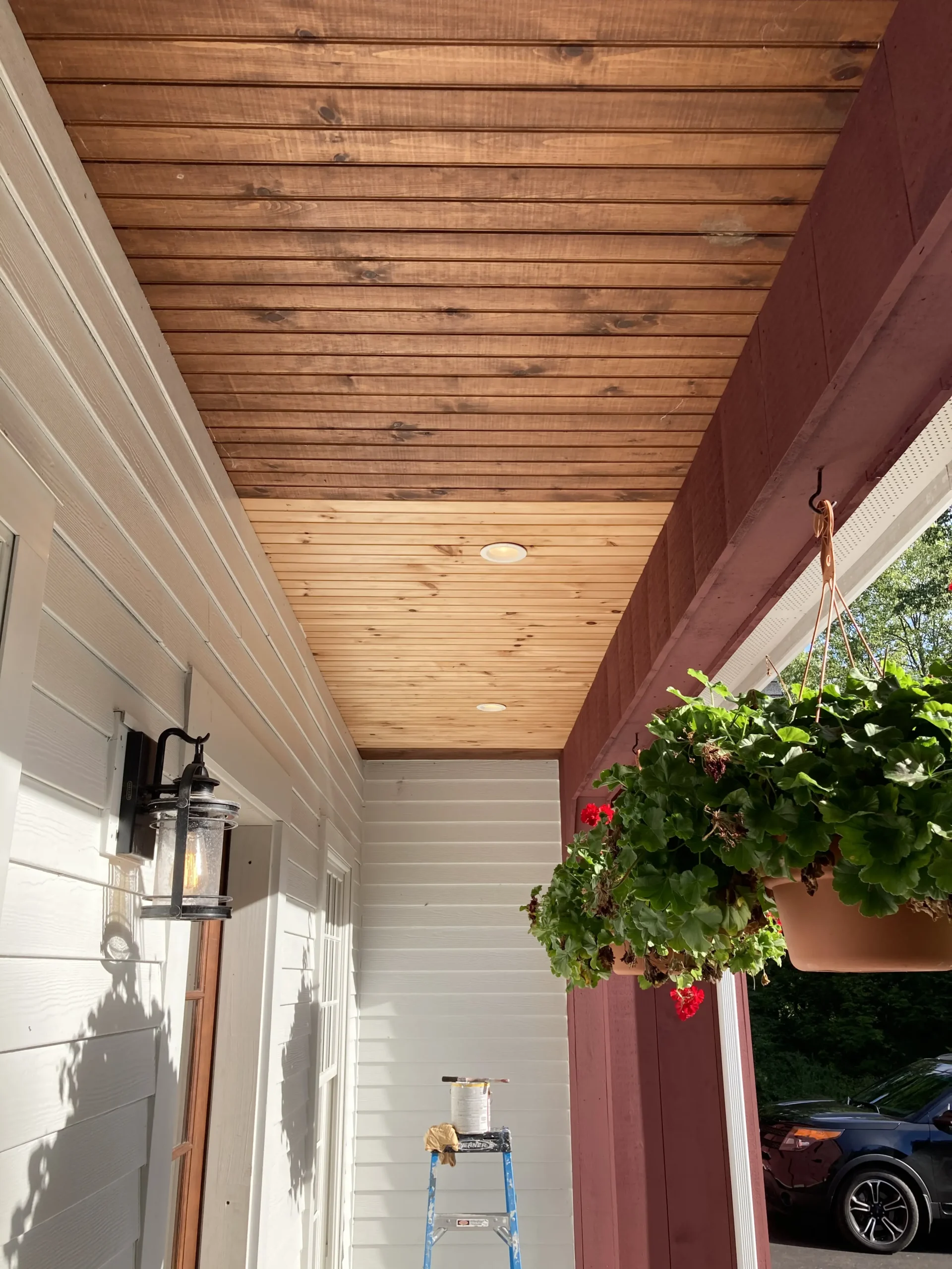 Front porch in CT with natural wood ceiling being stained.