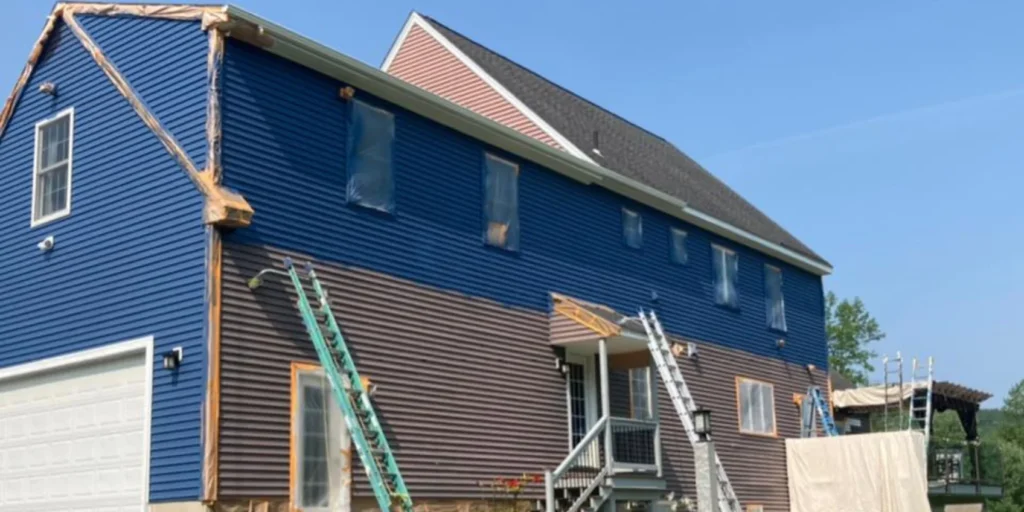 A Connecticut blue house being painted by a Connecticut professional painting contractor