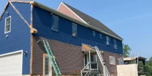 A Connecticut blue house being painted by a Connecticut professional painting contractor